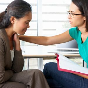 The Side View of Two Women Talking to Each Other