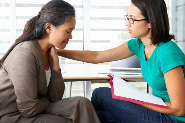 The Side View of Two Women Talking to Each Other