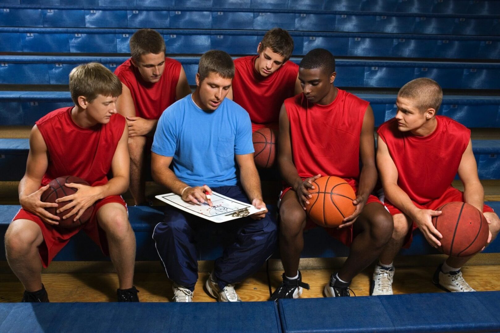 A Group of Basketball Players Around a Coach